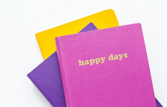 three assorted-color books