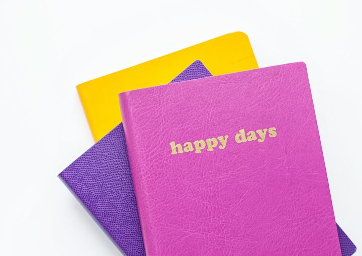 three assorted-color books