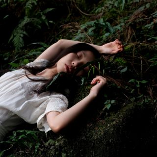 woman in white dress lying in white dress