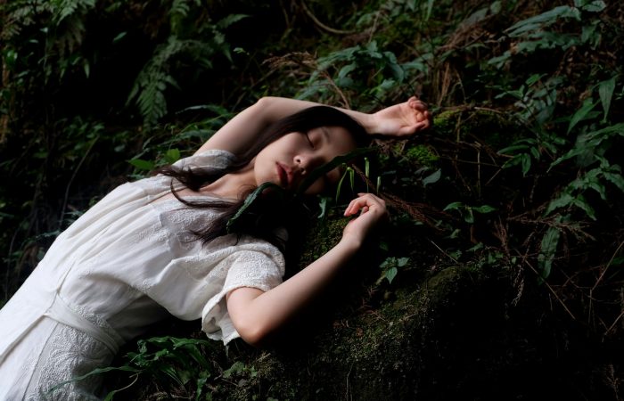 woman in white dress lying in white dress