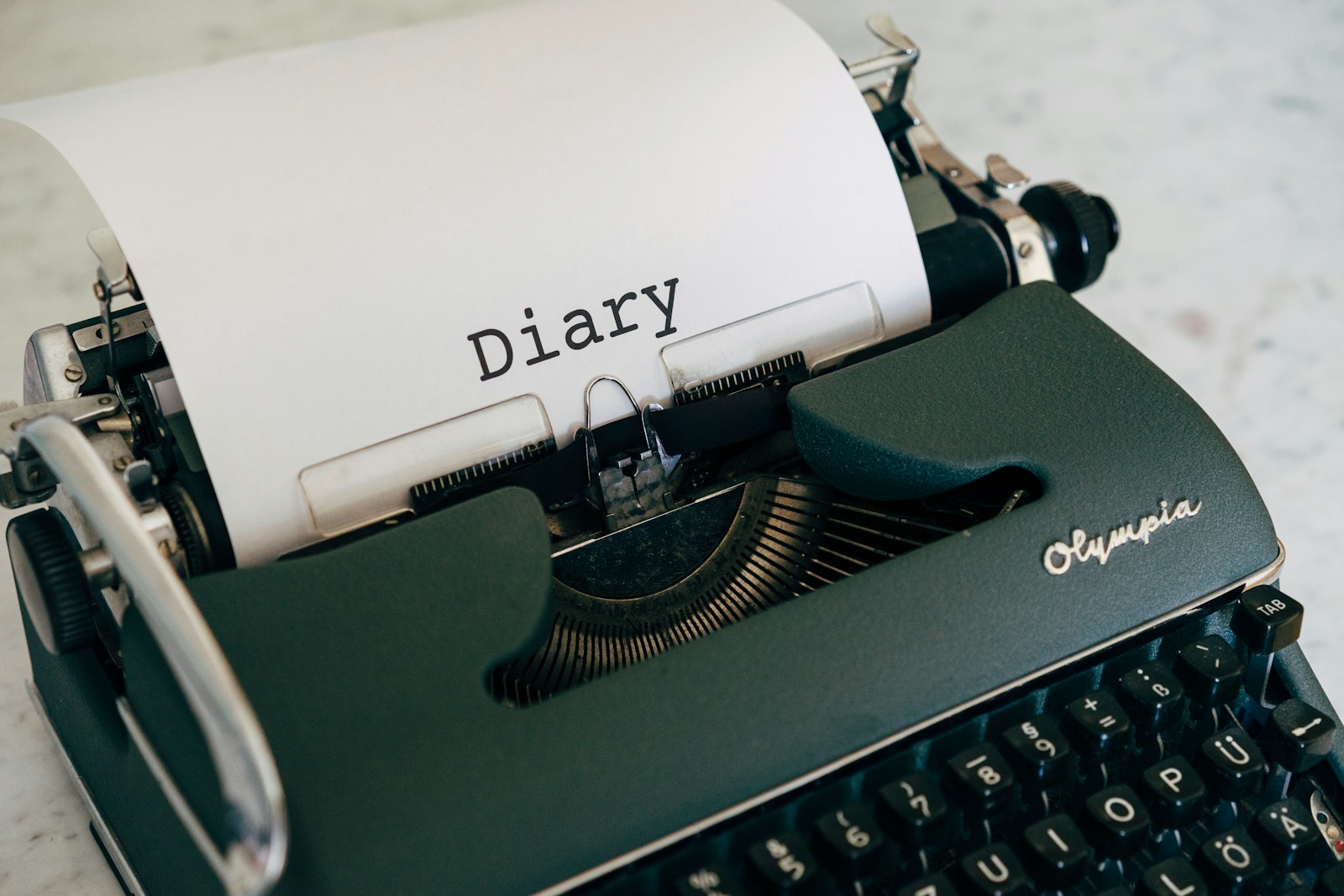 a close up of a typewriter with a paper on it