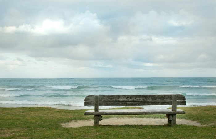 empty bench fronting sea
